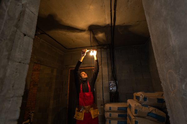 Builder handyman with construction tools. House renovation background