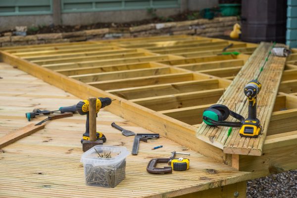 Image of tools, joists and planks, of a low level deck under construction